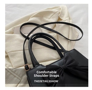 Detail of comfortable shoulder strap and smooth PU leather texture on the bow bag