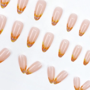 Long almond press-on nails with fall orange leaf pattern and silver glitter accents