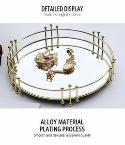 Close-up of golden mirrored tray with electroplated finish and ball-shaped fence details
