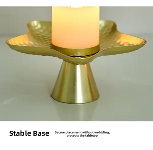Close-up of golden star-shaped candle holder with stable base on marble surface