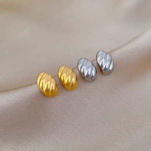 Minimalist twisted egg-shaped titanium steel stud earrings in gold and silver on silk