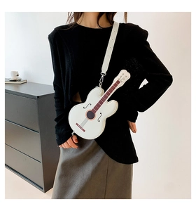 Detailed close-up of a white guitar-shaped PU leather crossbody bag worn by a model