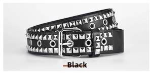 Detail of punk style PU belt with silver square rivets and metal eyelets on black leather