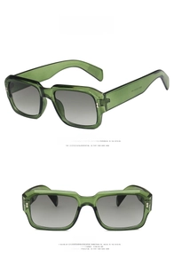 Detail view of transparent green oversized square sunglasses with grey gradient lenses