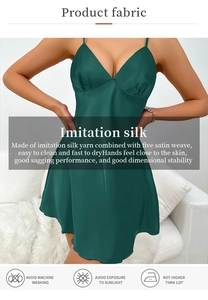 Detail of dark green satin nightdress showing the V-neckline and smooth silk texture