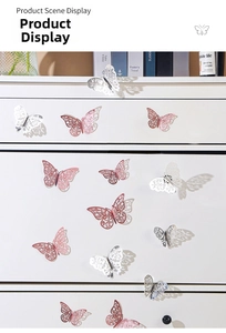 Detail of 3D hollow butterfly wall stickers in rose gold and silver on white furniture