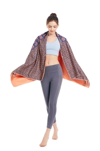 Detail of bohemian microfiber beach towel with ethnic print and absorbent orange lining