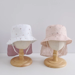 Close-up of children's sun hats with cherry embroidery and check pattern neck flap
