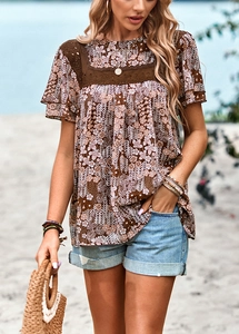 Detail shot of brown floral print top featuring lace patchwork crew neck and vintage pattern