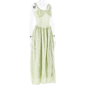 Detailed macro view of light green textured fabric and ruffle design on a maxi dress