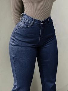 Detail view of high-waisted flare jeans showing the stretch fit and lifting effect