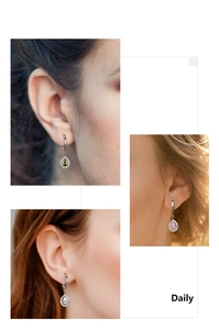 Detailed view of pear-cut zircon hoop earrings in green, pink, and white on a model