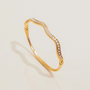 Dettaglio di bracciale in acciaio inossidabile 18K con design ondulato e zirconi cubici
