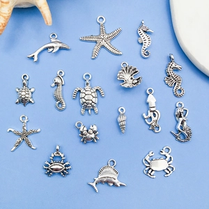 Detailed collection of 15 silver Tibetan alloy ocean charms including starfish and seahorse