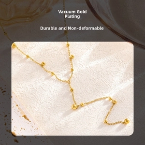 Detailed close-up of a 14k gold plated beaded chain bracelet with polished sphere accents