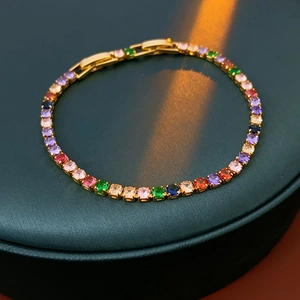 Detail shot of a gold-plated tennis bracelet with colorful cubic zirconia stones
