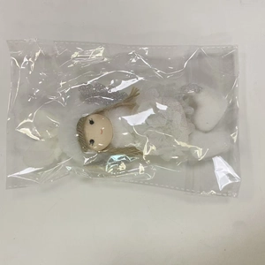 Close-up of a plush white angel doll ornament with silver wings and lace skirt details