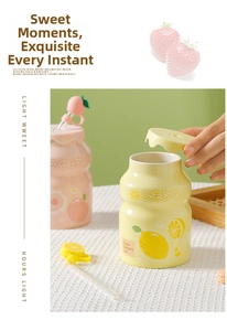 Close-up of ceramic milk-bottle style mugs with fruit lids and glass straws