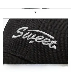 Detailed close-up of Sweet silver 3D embroidery on breathable black mesh baseball cap