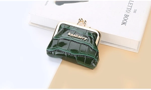 Detail of green crocodile texture coin purse with classic vintage metal clasp closure