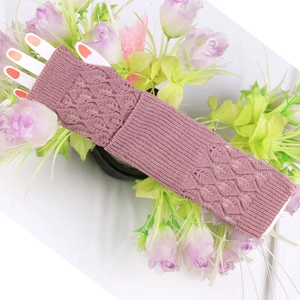 Detail of lotus pink knit fingerless gloves with elegant hollow diamond leaf pattern