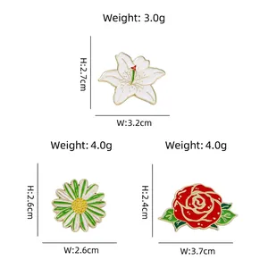 Three-piece set of enamel flower brooches including lily, daisy, and rose designs