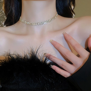 Close-up of sparkling gold rhinestone choker necklace worn by a fashion model