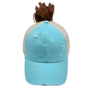 Detail of light blue distressed baseball cap featuring crisscross back for ponytail and mesh