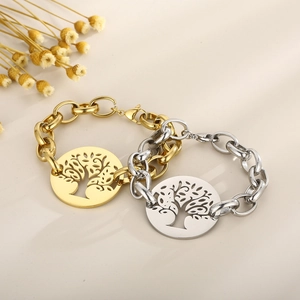 Detail of tree of life pendants on chunky chains in gold and silver finishes