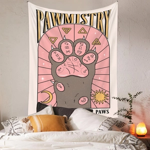 Detail of bohemian tapestry featuring pawmistry cat paw design over a bedroom headboard
