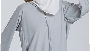 Detail of grey sun protection jacket featuring breathable face mask and metal zipper