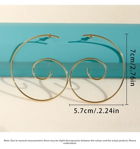 Detailed view of large gold spiral earrings with size dimensions 7cm by 5.7cm on a box