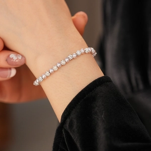 Close-up of grey pearl bracelet with crystal-studded beads on a velvet background