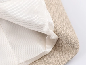 Detail of oatmeal woven fabric and smooth white silk lining of a casual women blazer