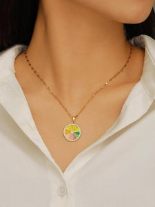 Detailed view of gold chain necklace with colorful lemon fruit slice enamel pendant