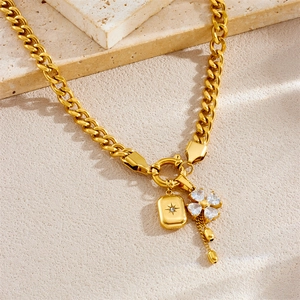 Gold Cuban chain necklace with star rectangular pendant and clover tassel on stones