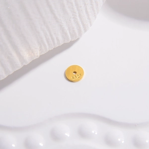 Detailed view of round S925 sterling silver golden spacer bead with material hallmark