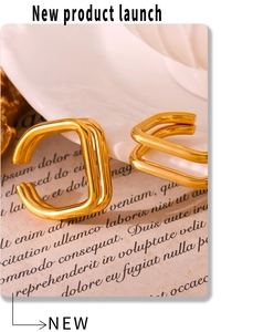 Macro shot of 18K gold plated double-layer square ear cuffs on a vintage paper background