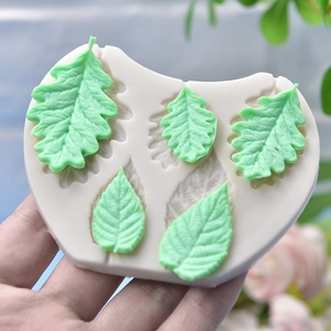 Leaf-shaped silicone molds with detailed clay leaf outputs for DIY cake decorating