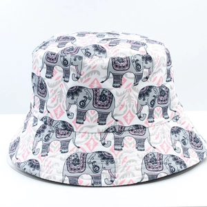 Close-up of elephant print and pink geometric patterns on a white reversible bucket hat