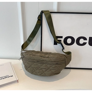Detail of olive green quilted nylon chest bag showing diamond stitch pattern and strap