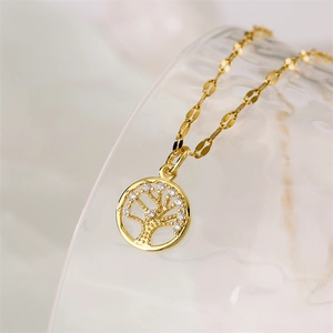 Macro shot of polished gold tree of life necklace pendant with white crystal details