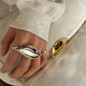 Exaggerated leaf shaped open rings in polished gold and silver metal finishes for women