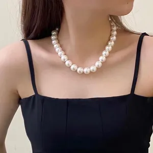 Classic French vintage necklace with large 14mm round white pearls on a female model