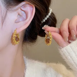 Vintage gold textured resin hoop earrings for women featuring a brown center stone