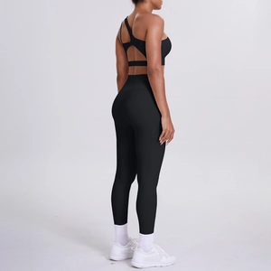 Detail of cross-back hollow design on a black yoga bra and high waist fitness leggings