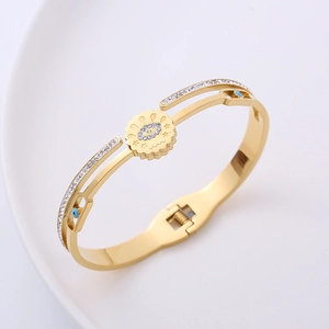 Detailed view of evil eye spring bangle with blue enamel and sparkling rhinestones