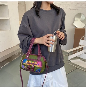 Detail of colorful patchwork soft leather handbag with metal rivets and shoulder strap