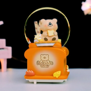 Detail of Capybara resin snow globe with toaster base and bear inside for car decor