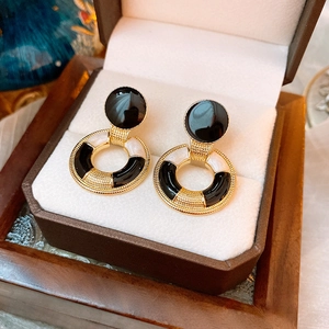 Vintage enamel heart earrings in black and white gold on a premium brown jewelry box